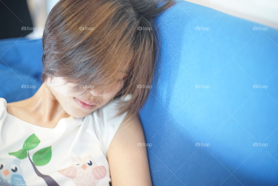 Asian girl sleeping on sofa