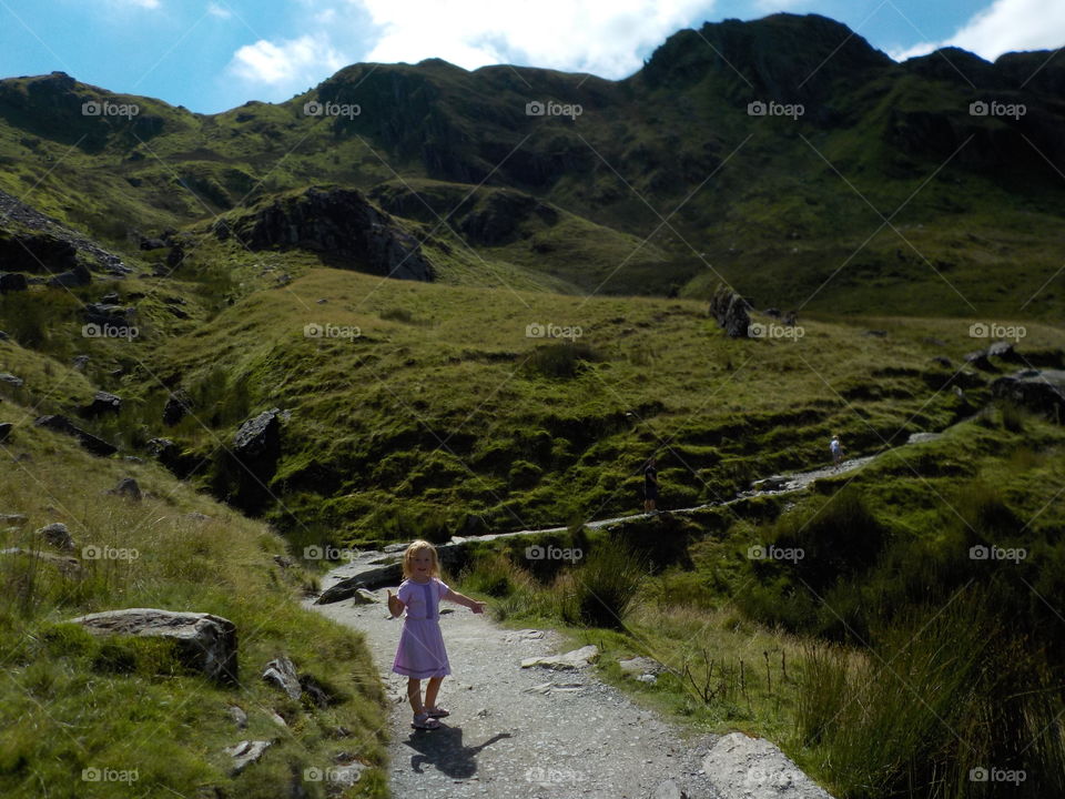 A little girl on footpath at mountain