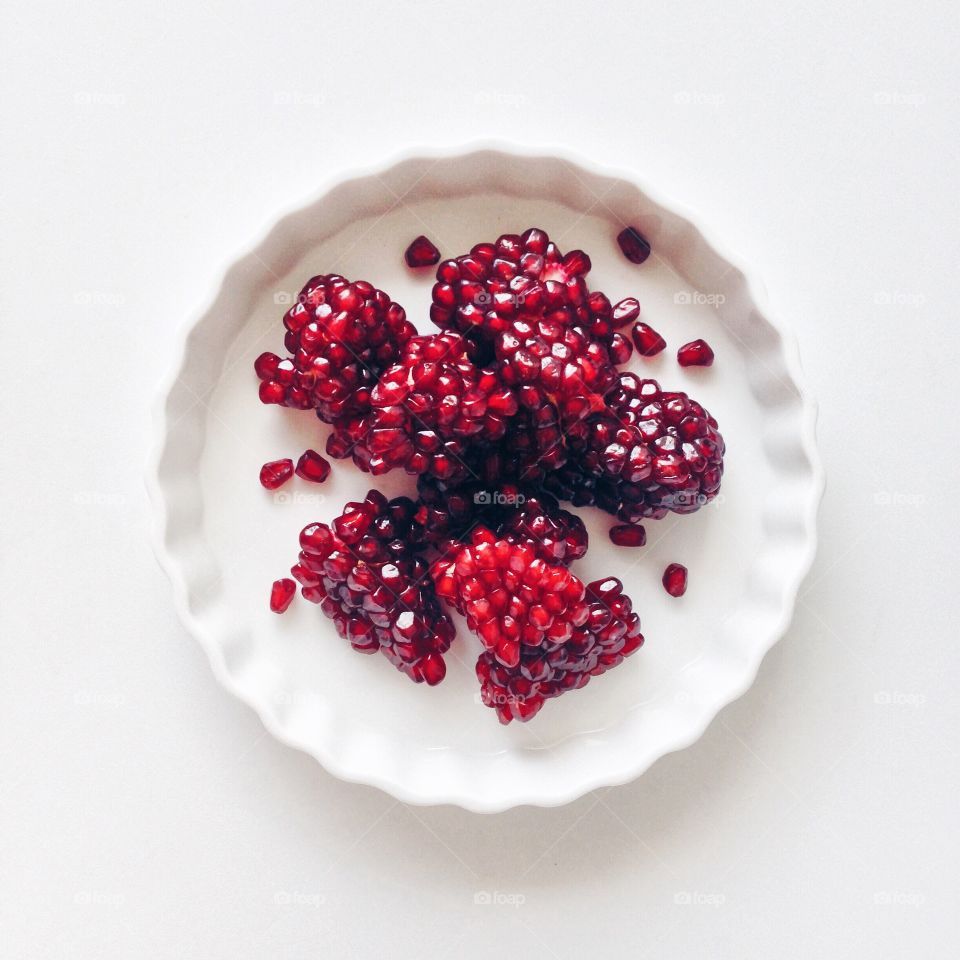 Ripe pomegranate on a white plate