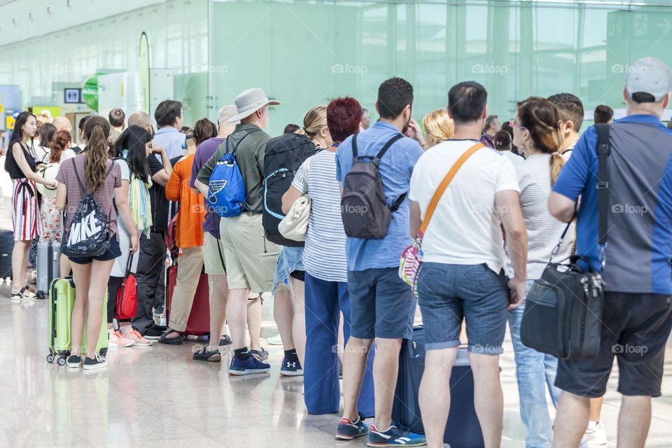 People gathering at the departure gates at the airport