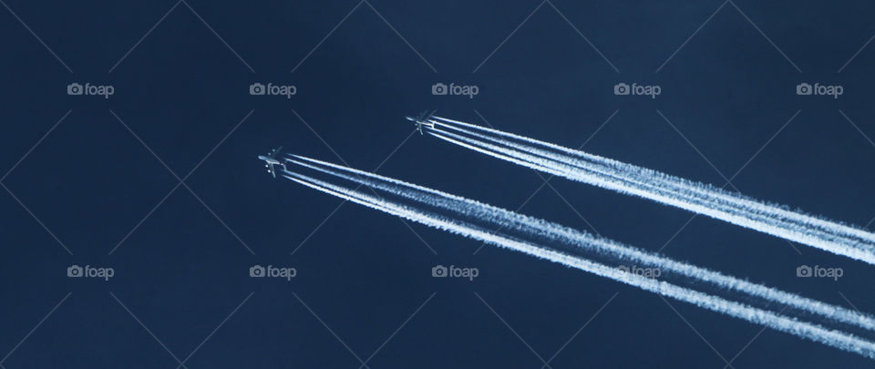 Low angle view of vapor trails