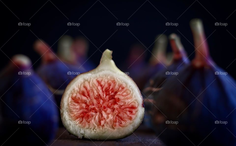 Purple figs, with one cut in half revealing its red centre