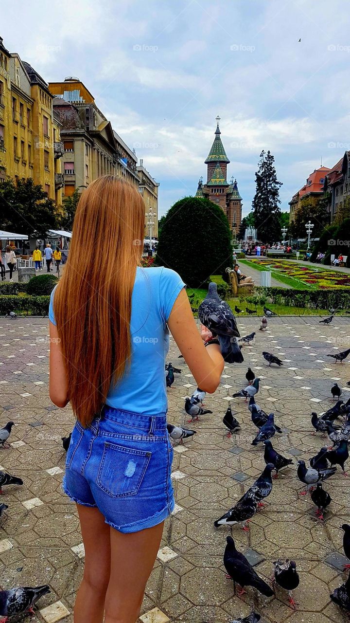 young girl with a pigeon on her hand