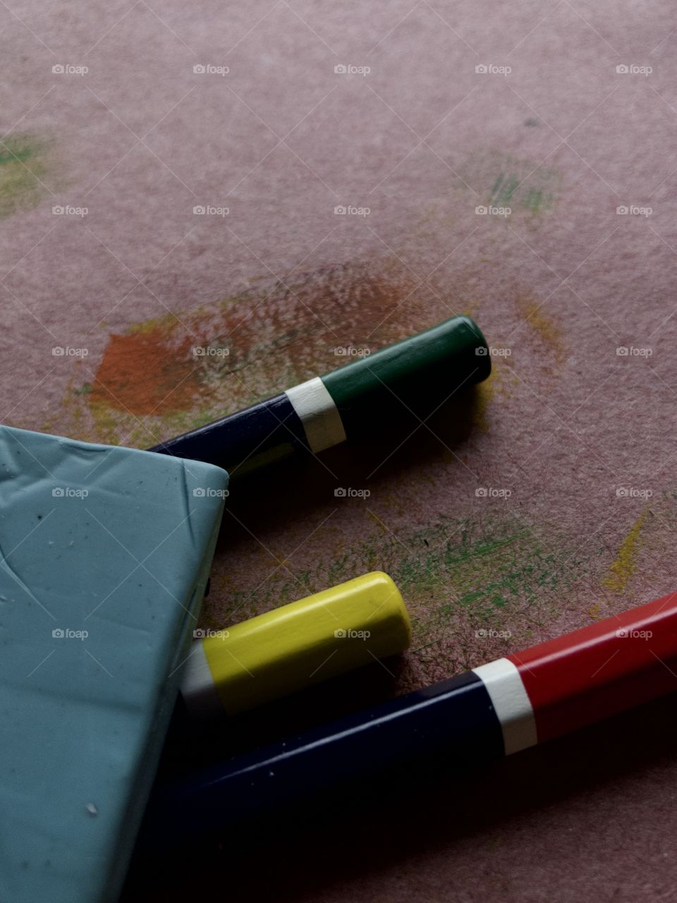 Red, green and yellow pencils and rubber