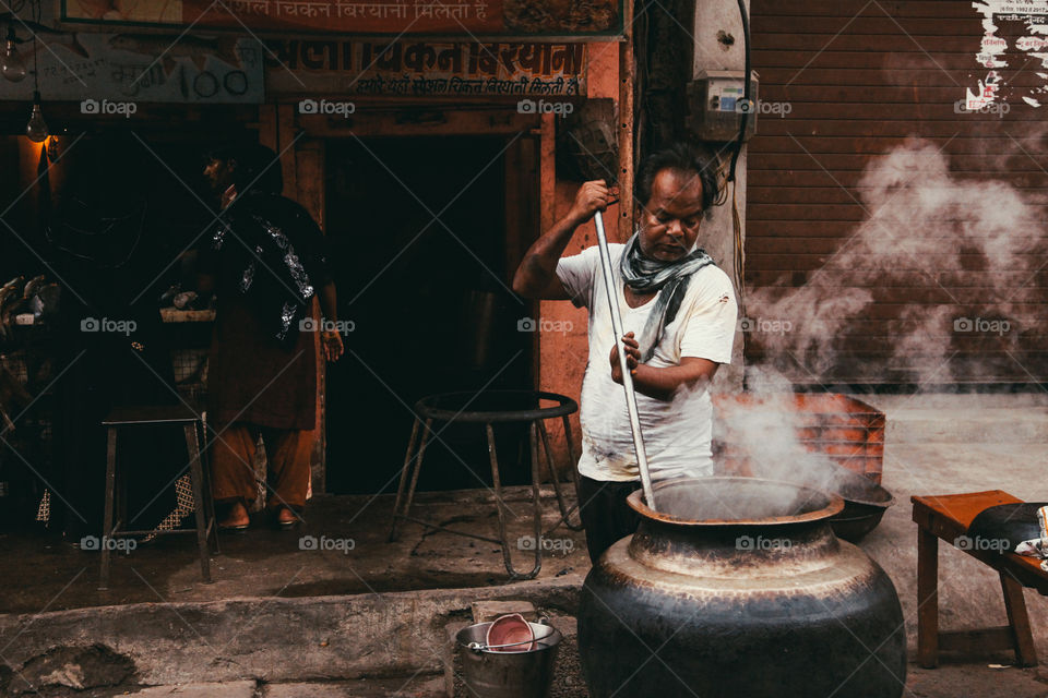 A street vendor prepares food in the streets of Jaipur, India
