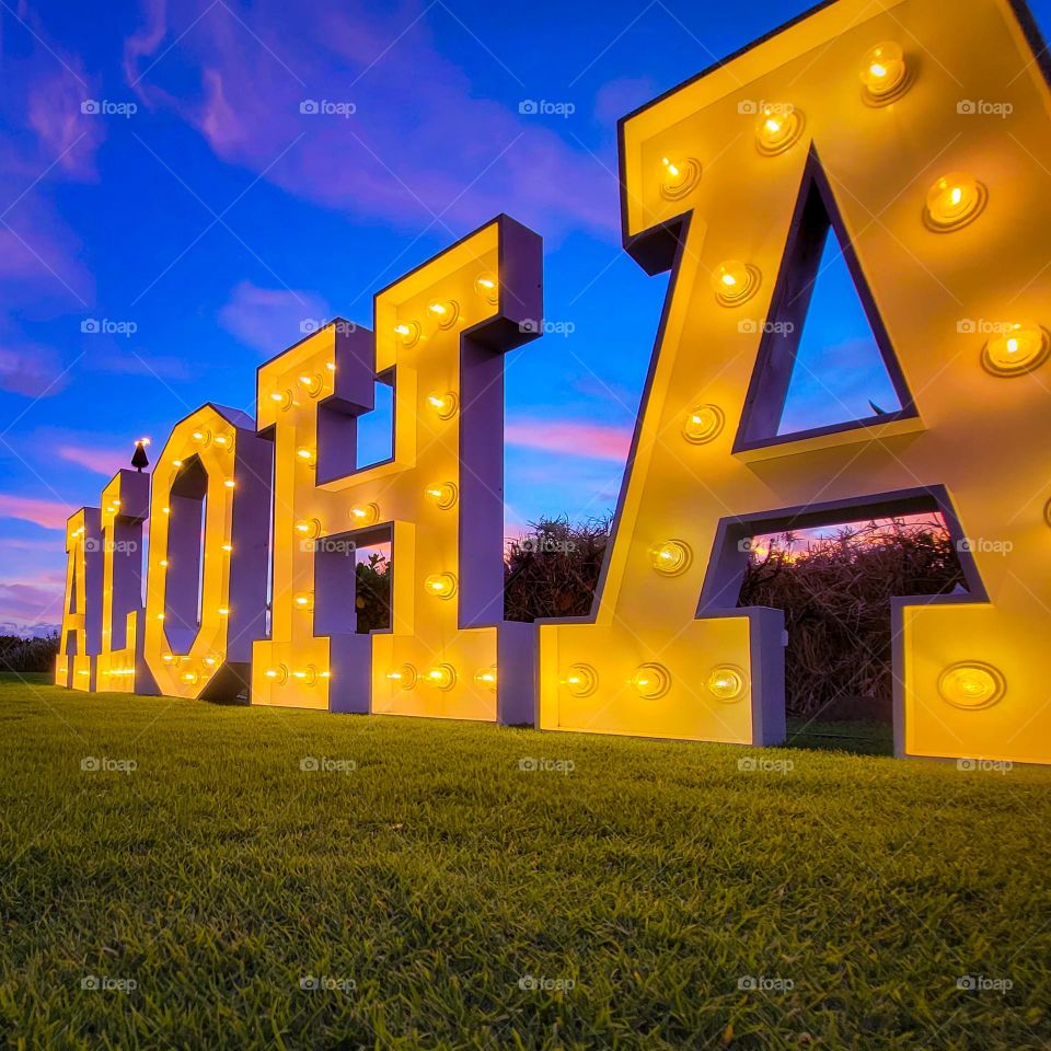 Huge Aloha sign, lit up at dusk in Hawaii.