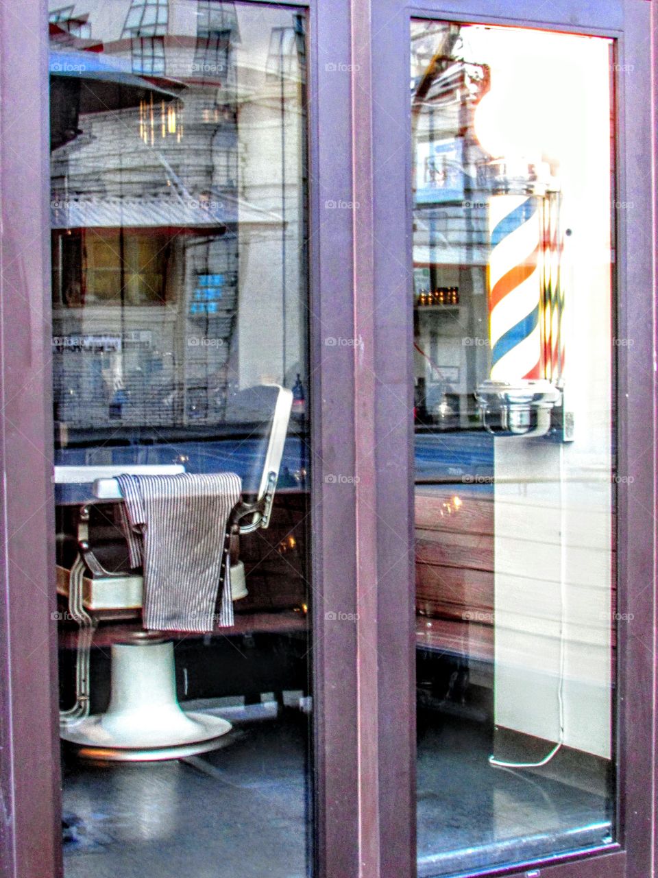looking through a window at a barber shop chair