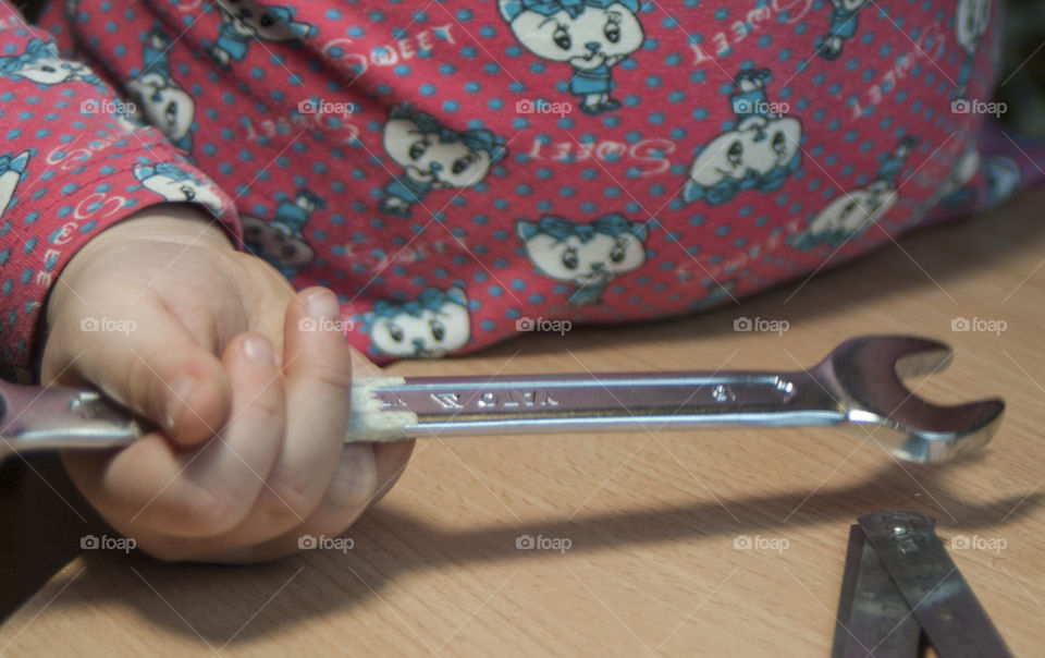 little girl holding tools