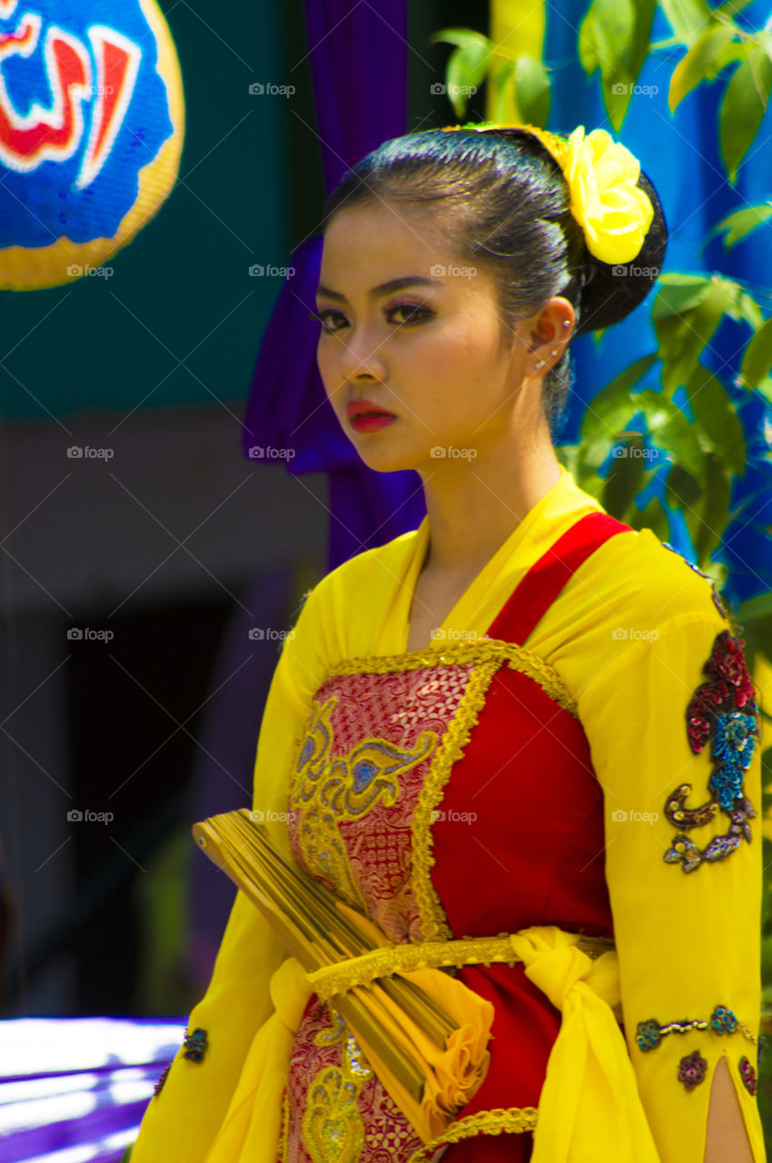 Asian woman in yellow traditional dress