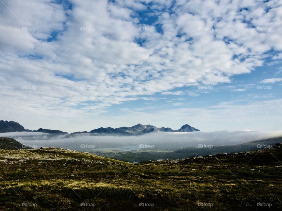 A view to mountain with fog below