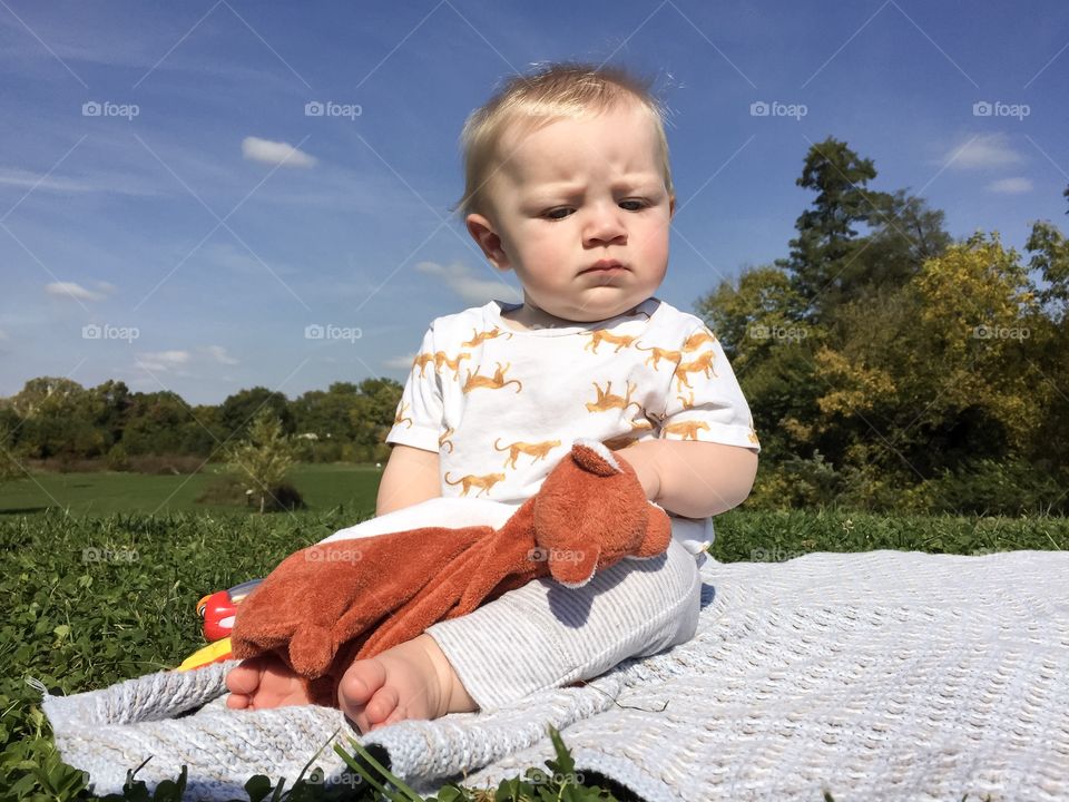 Cute curious baby boy playing outdoors 