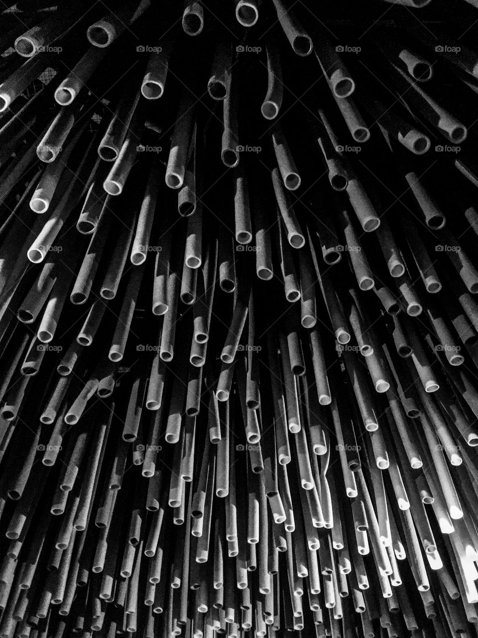 Creative background made from foam pipes. Construction elements. Recycling. Black and white foam pipes texture. 