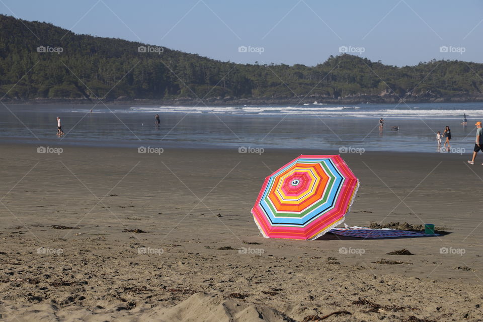 Umbrella on the sandy beach by the ocean