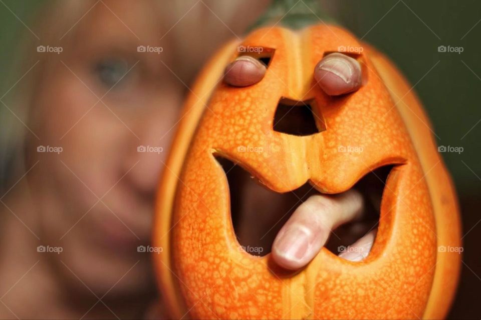 A woman stuck her fingers through a Jack O'Lantern