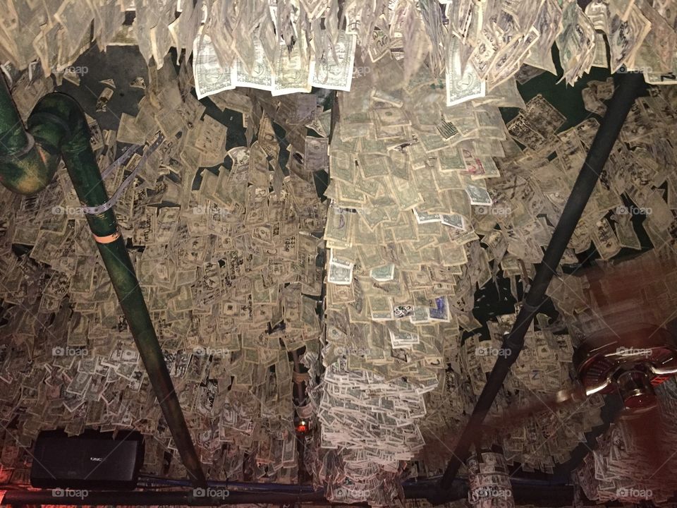 The ceiling (and walls) of McGuires Irish Pub in Destin, FL IS *covered* with cash!!!