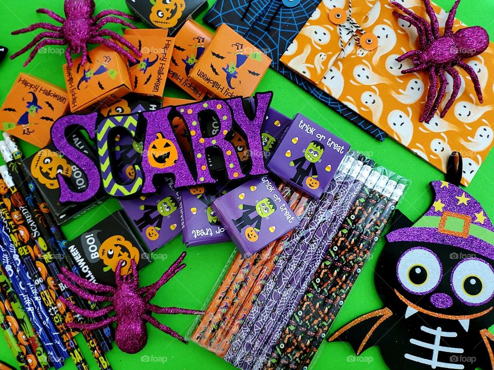 Flat lay Halloween kids treats on bright green background with the word scary