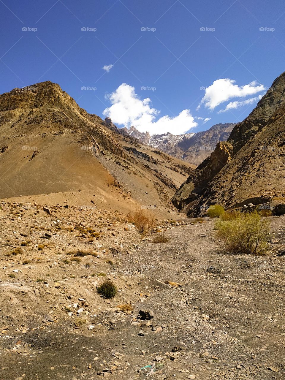 mountain in the Himalayas on the blue sky background with clouds