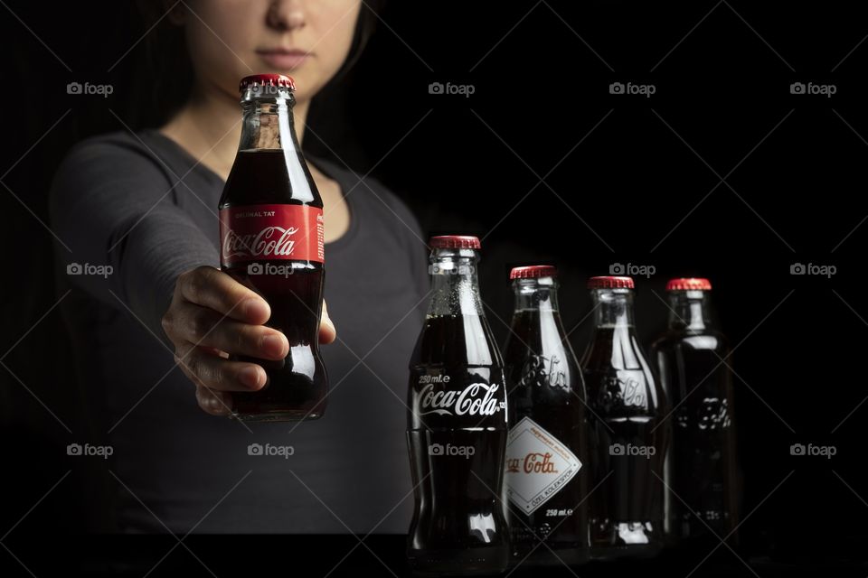 Woman holding Coca Cola bottle