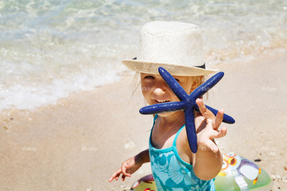 Cute little girl with starfish 