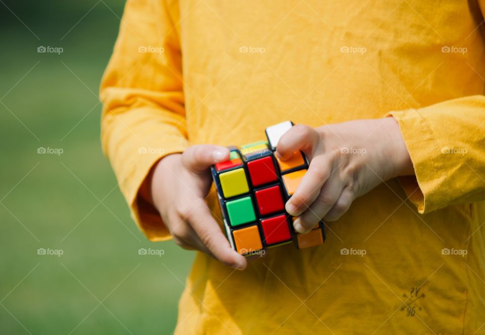 Child playing with the Rubik’s cube 