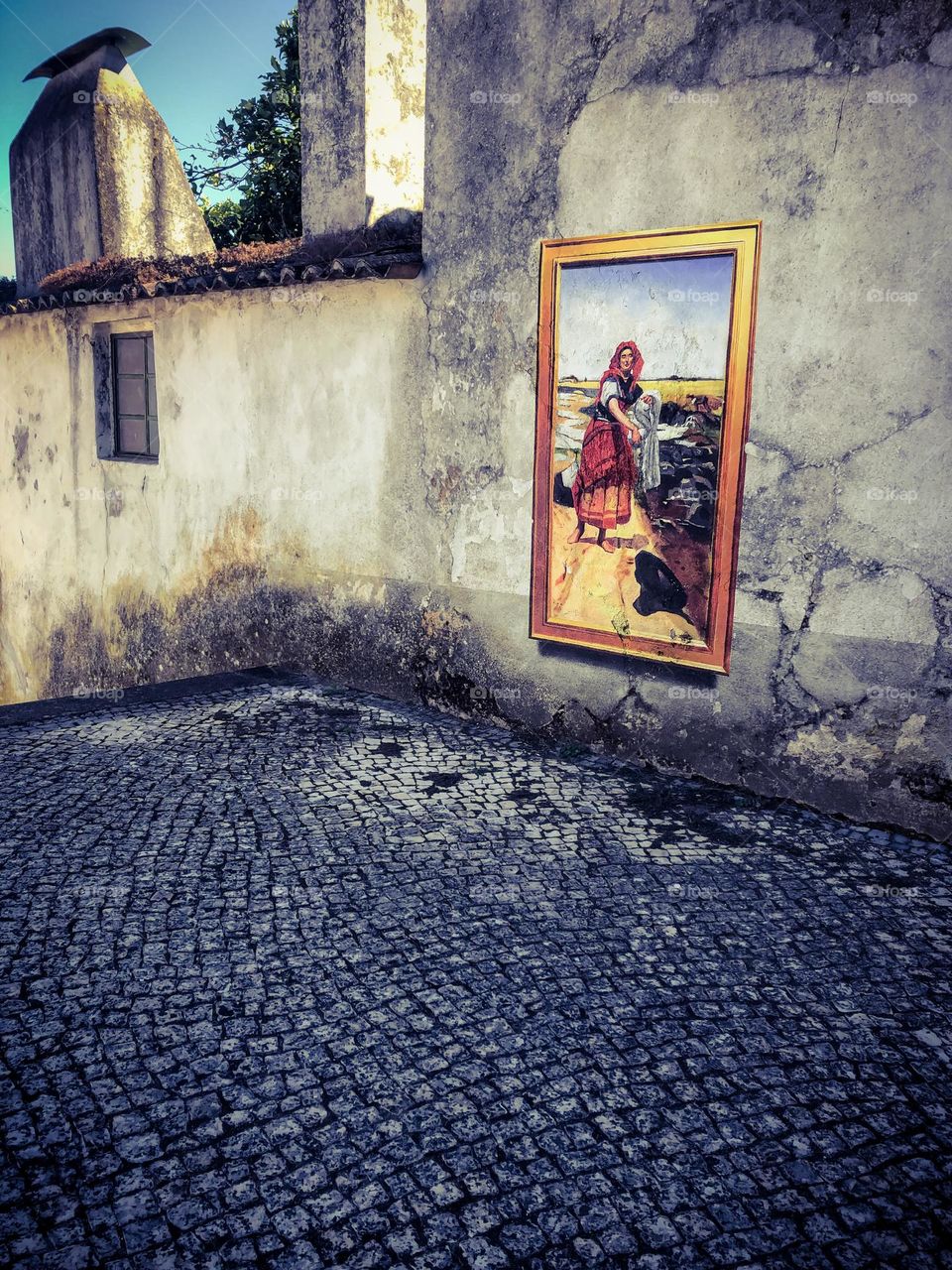 A mural, including a painted on frame on a wall in Figueiró Dos Vinhos, Portugal as part of an annual street art exhibition. It is a recreation of  "José Malhoa. Clara, 1903" by Julio Anaya Cabanding 