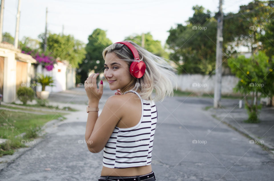 Blonde listening to music on headphones