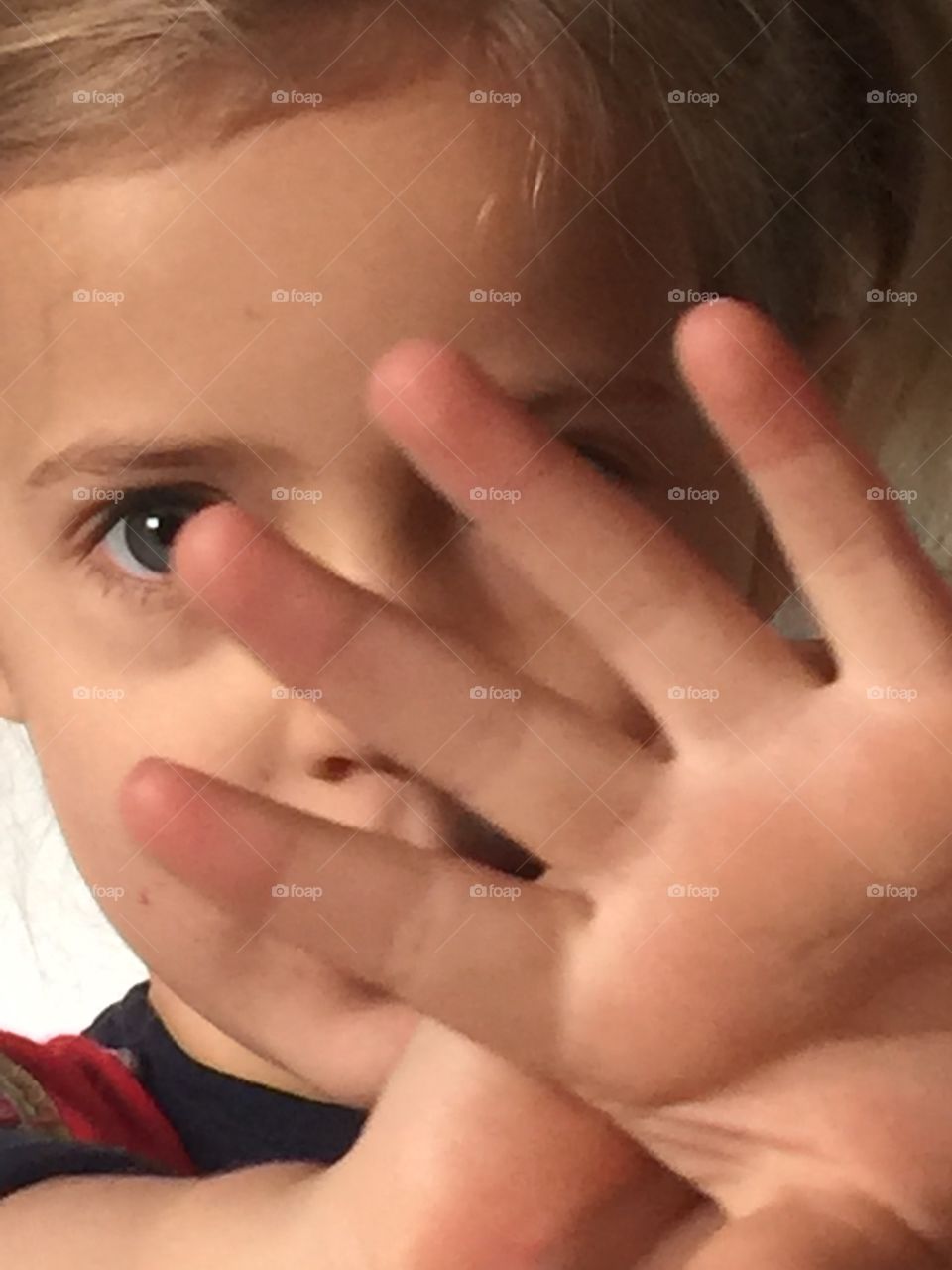 Child covering its face