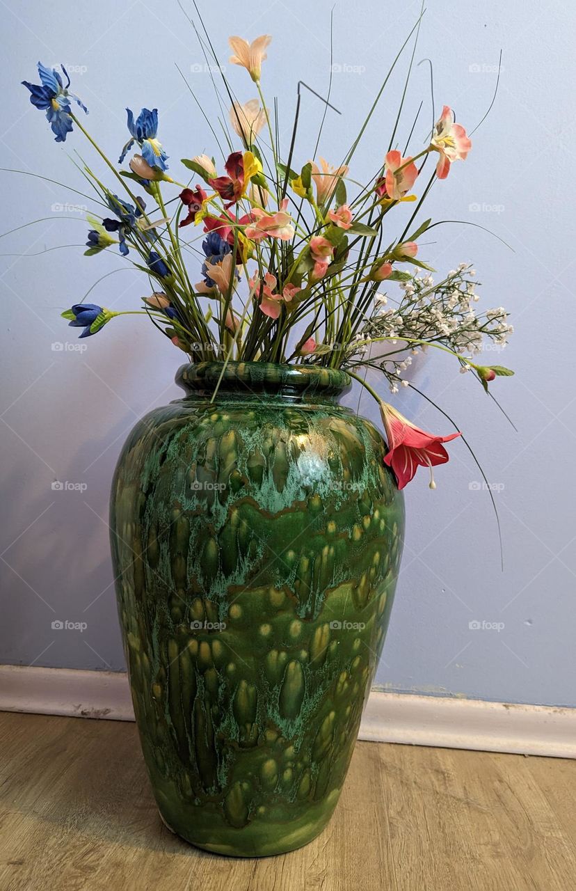 green vase  full of flowers