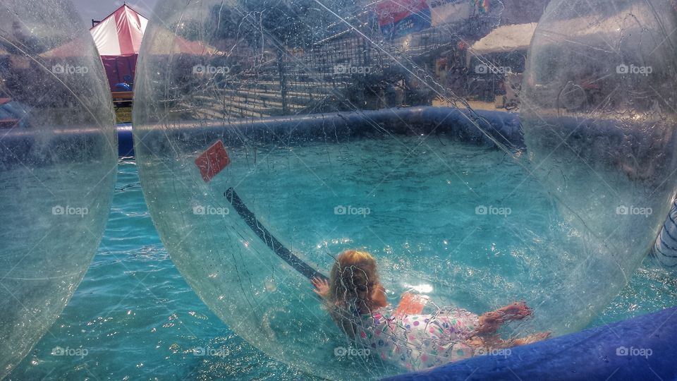 Inflatable Water Bubble. Girl Having Fun at Fair