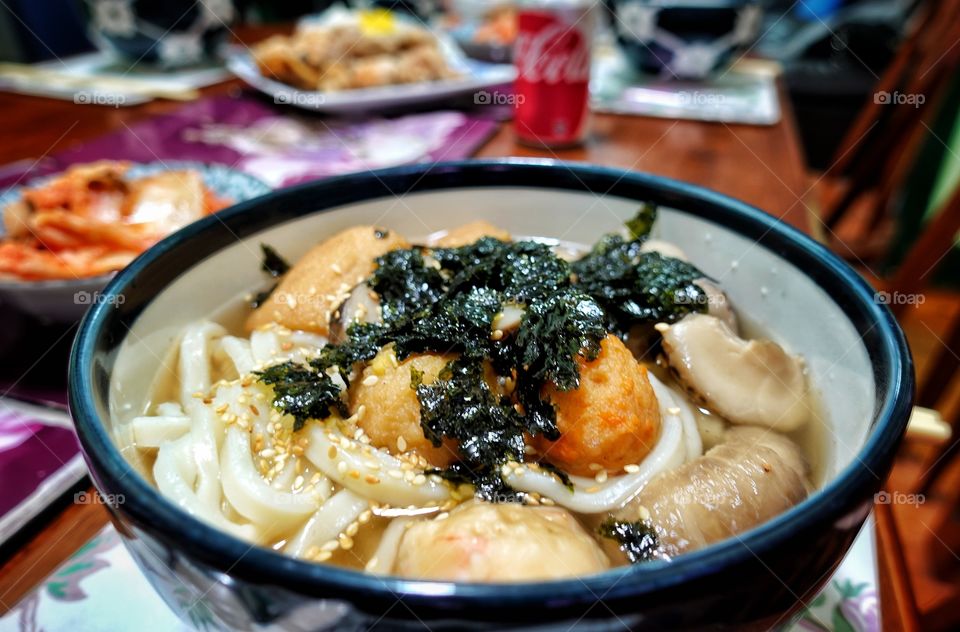 Oden udon noodle soup with shiitake mushrooms, topped with dried seaweed flakes. A popular food item in Japanese and Korean cuisine.