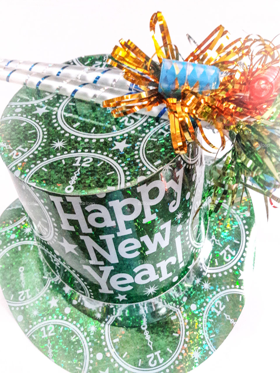 Happy New Year! Green New Year's hat and, colorful noise makers.