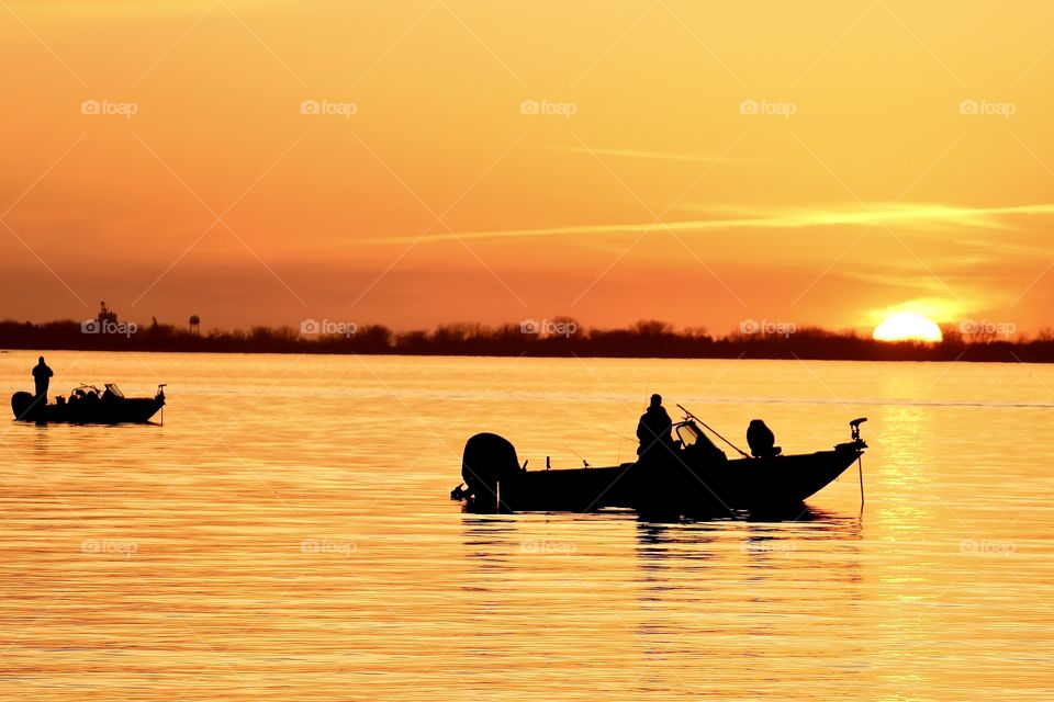 Gorgeous golden hour sunset with silhouetted fishermen enjoying their catches of the night! 