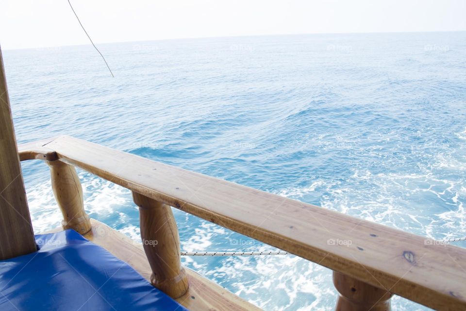 A ship sailing on the waves of the blue sea.