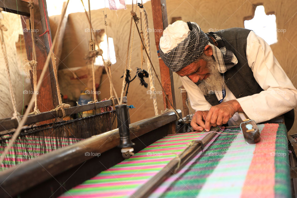 A traditional Indian carpet weaver