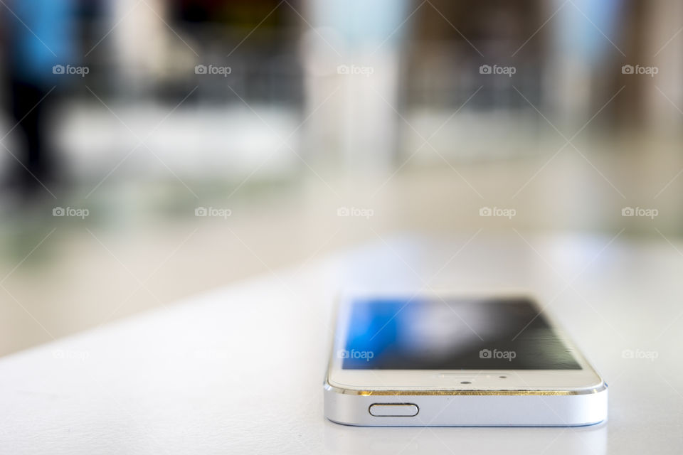 White phone Reflection on the table