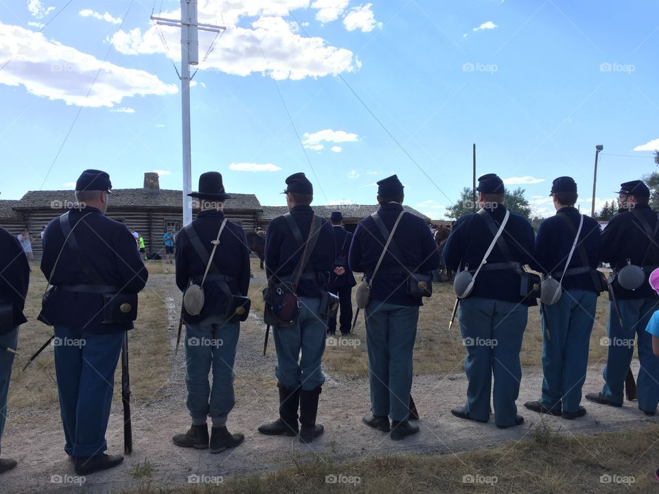 History Reenactment . Volunteer history reenactors stand on the Fort Caspar parade grounds in Casper, Wyoming 