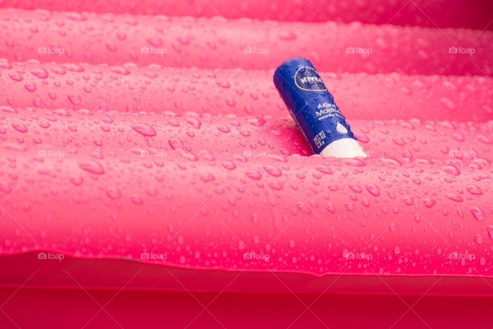 A Nivea lip balm on a wet air bed 