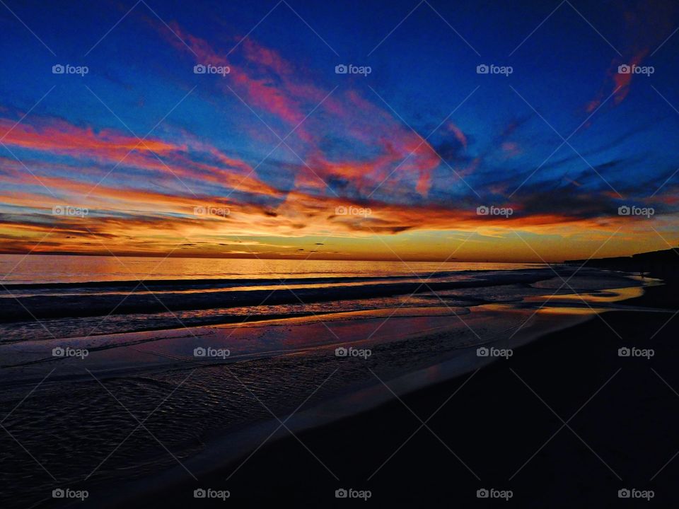 The sunset was a perfect conclusion of the day. It was silky, smooth collusion of sky burst reds, yellows, blues, various hues, orange, tangerine and metallic gold