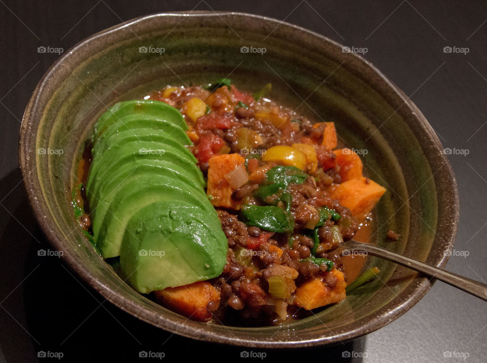 Mexican lentil stew with sliced avocado 