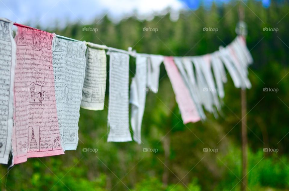 Hanging prayer flags on the Himalayan mountain