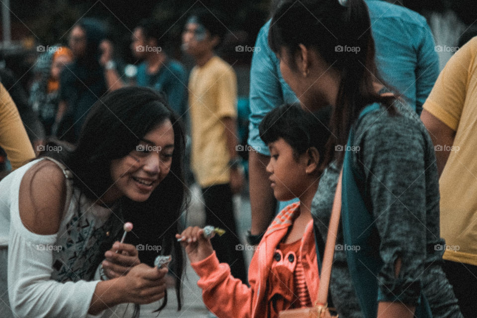 she is giving candy to a child to voice non-violence against children

(Malioboro Street, Yogyakarta )