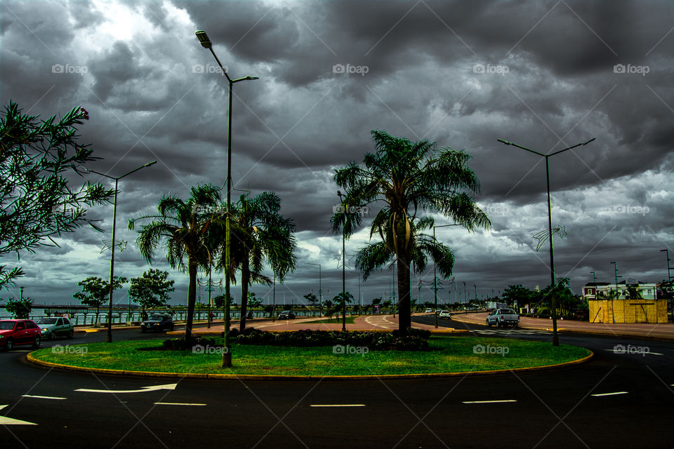 Scenic view of road against storm cloud