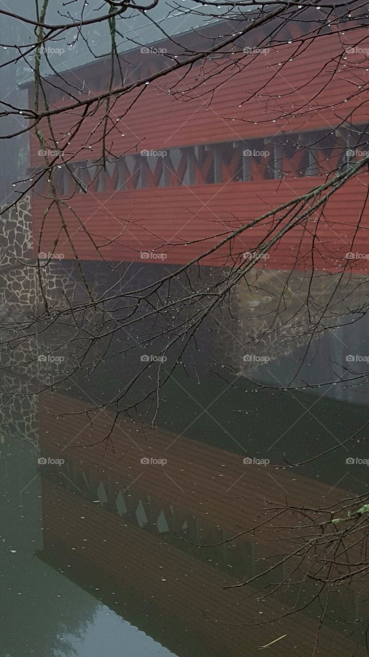 covered bridge reflection on a rainy day