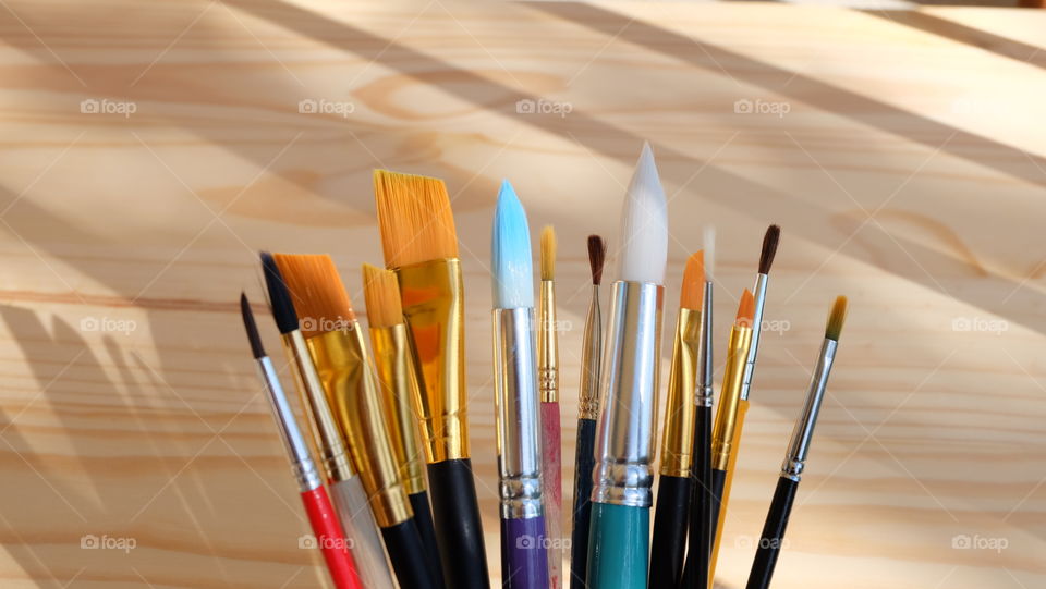 Paintbrushes against wood