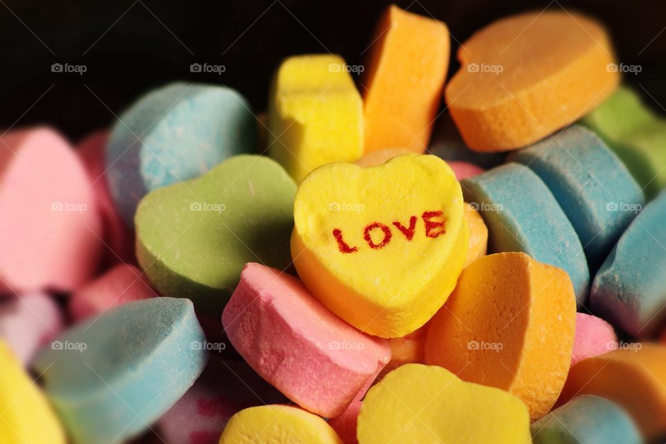 Heart shaped valentines Day candy with the word love printed on it
