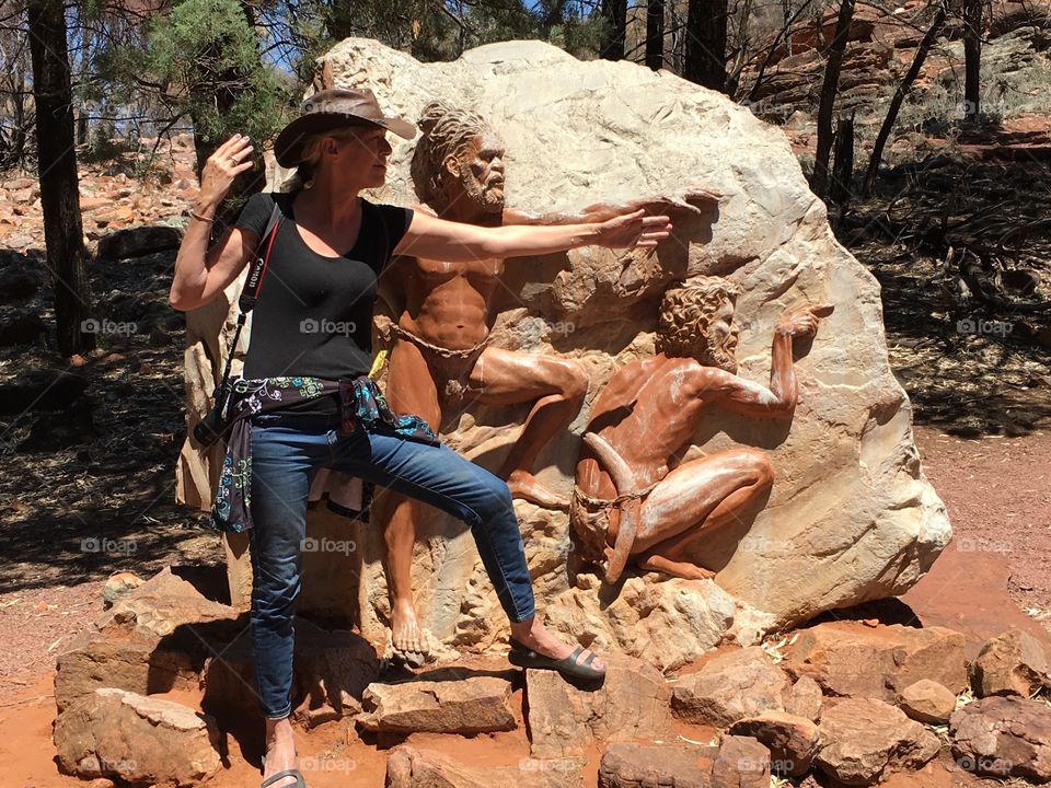 Female photographer in Flinders Ranges National Park beside aboriginal history rock
