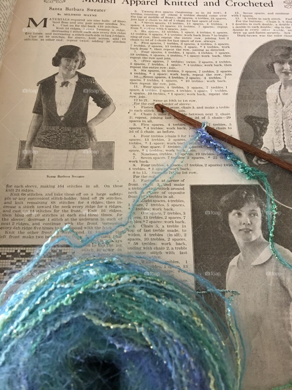 Yarn and crochet hook on vintage magazine page