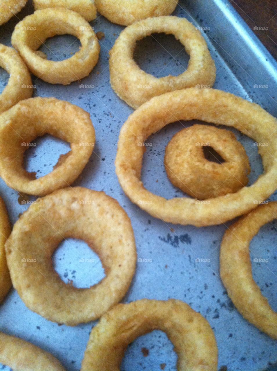 Baked onion rings. Onion rings on baking sheet