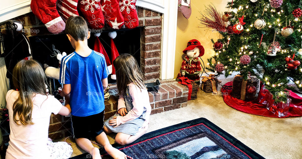 Kids helping with Christmas decorations.