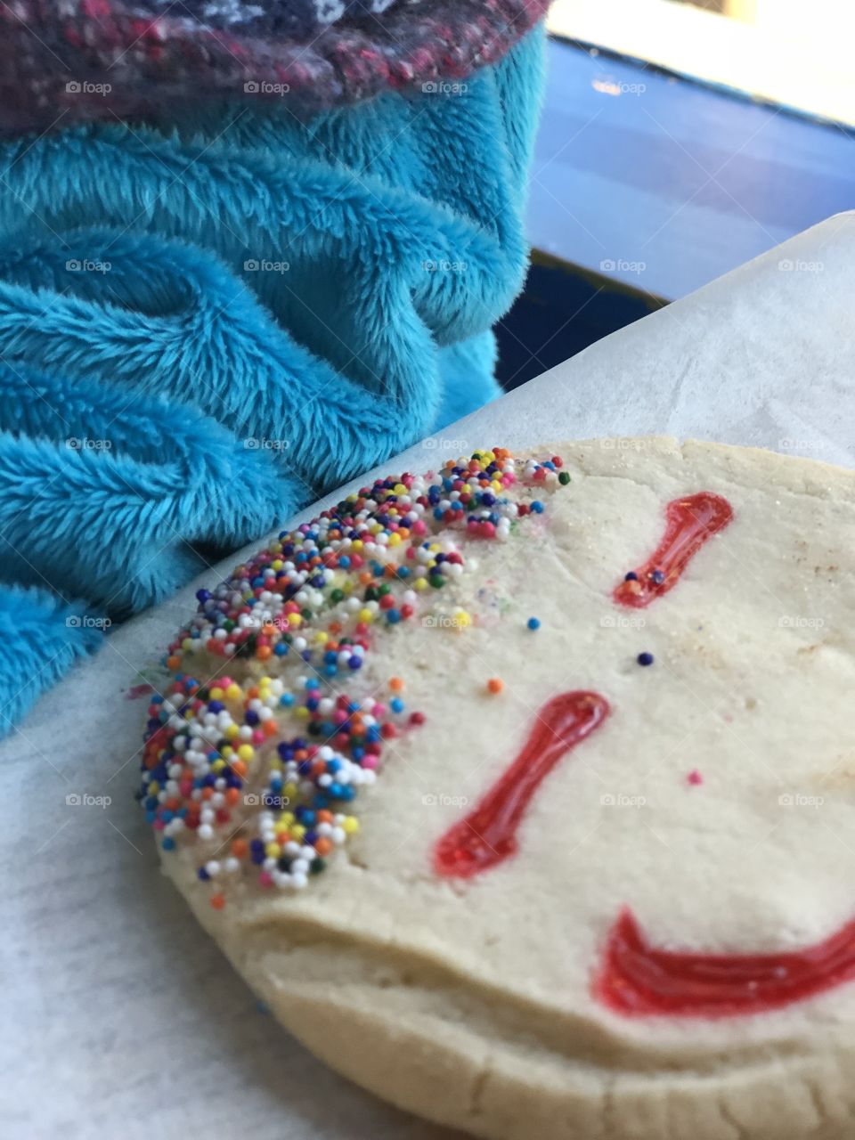 A sugar cookie with a face and sprinkles for hair 